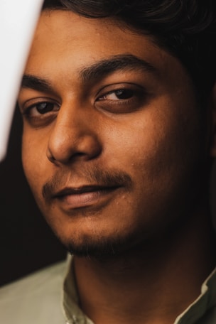A close-up portrait of a person with expressive eyes and soft natural lighting highlighting their features.