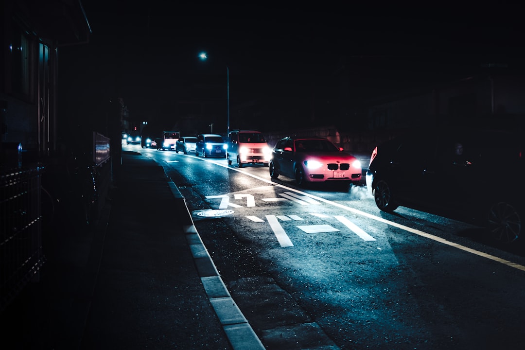 red car on road during night time