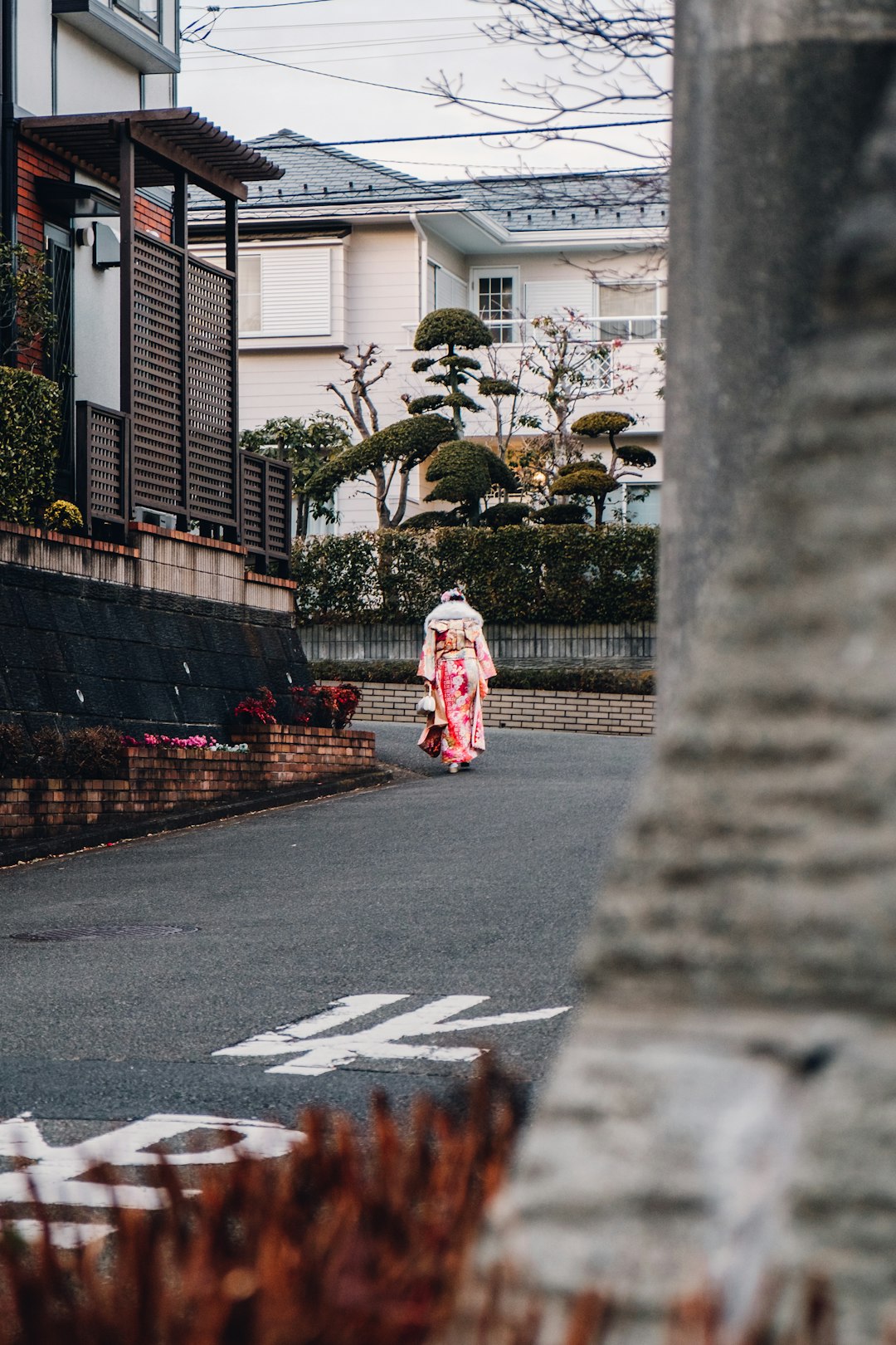 woman in white and red dress walking on pedestrian lane during daytime