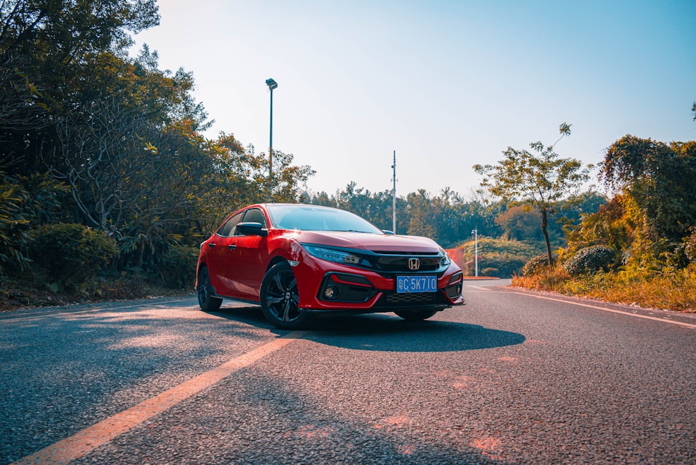 red chevrolet camaro on road during daytime