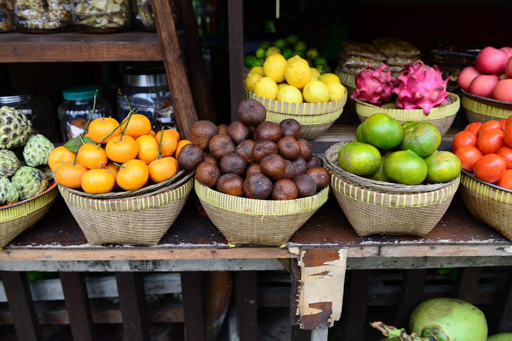 green apple and orange fruits on brown woven baskets