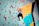 A focused climber gripping a colorful hold on a steep indoor wall inside picoviva gym.