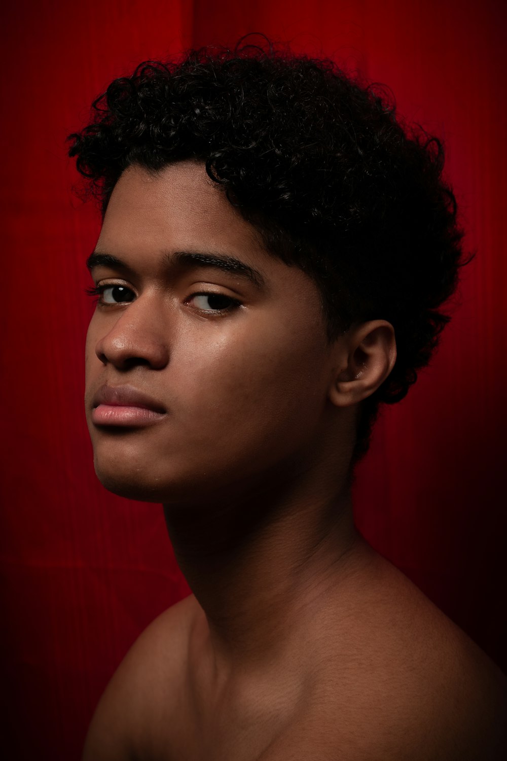 topless boy with black curly hair