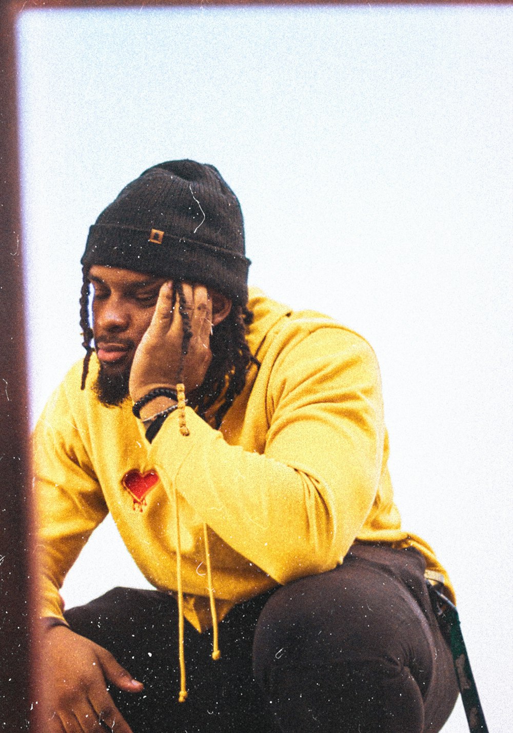 man in yellow jacket and black knit cap