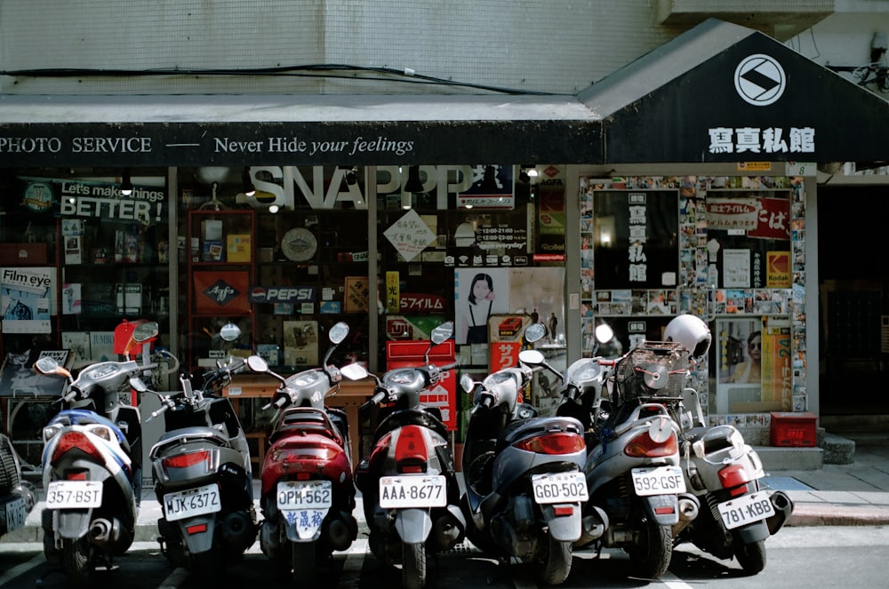 red and black motorcycle parked near store