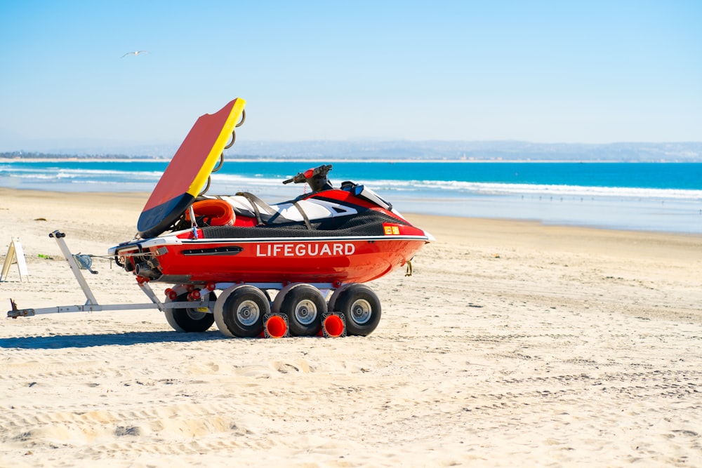 red and black boat on beach during daytime