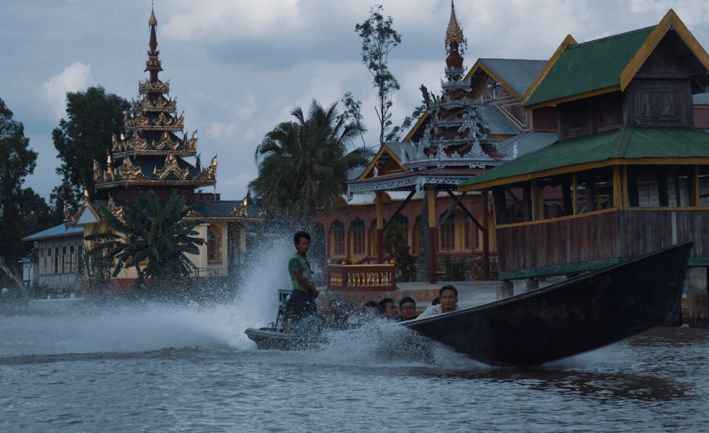 man in black jacket riding on boat during daytime