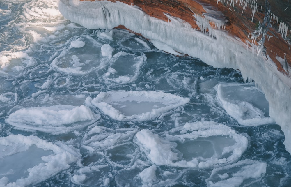 white ice on body of water