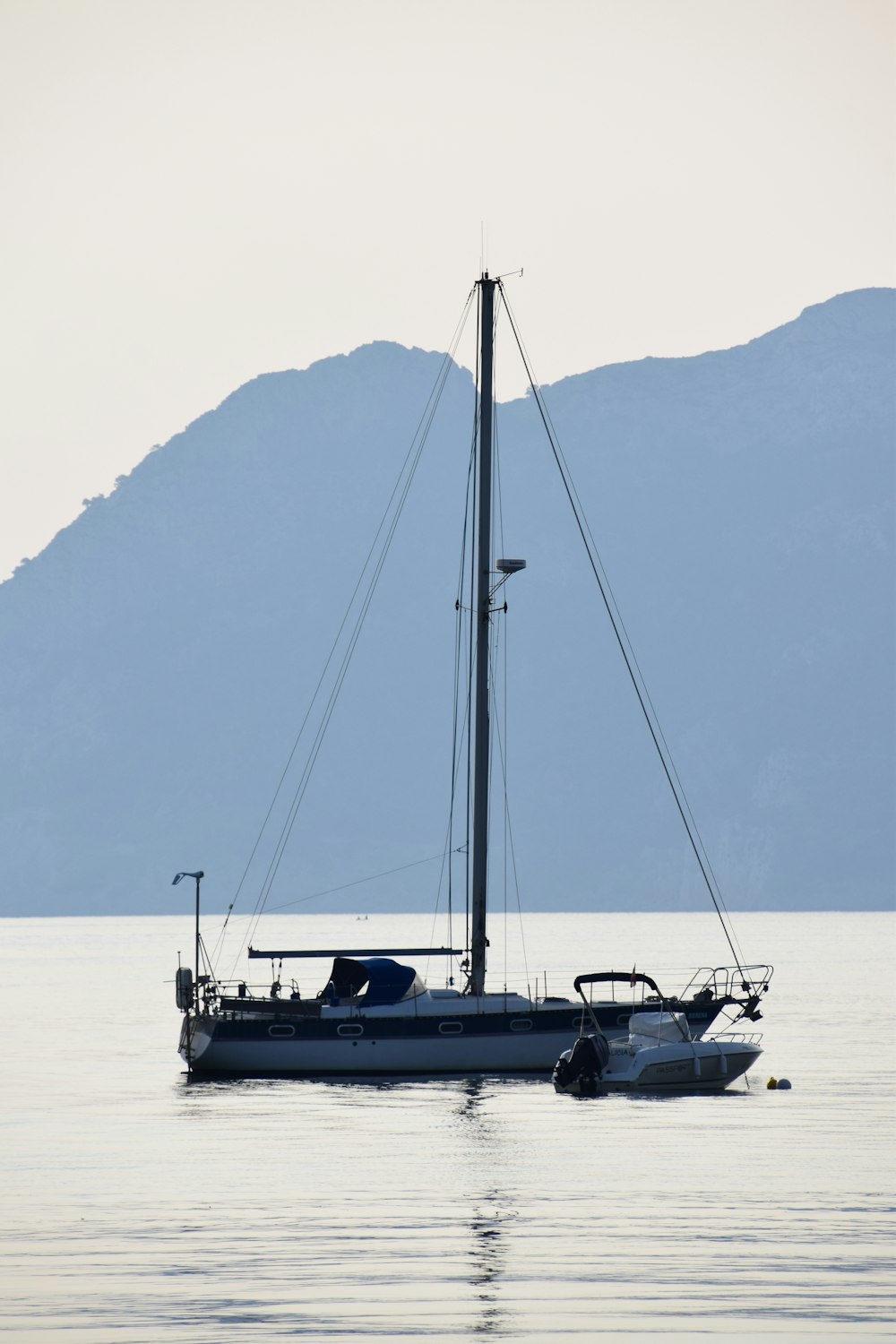 white and black sailboat on sea during daytime