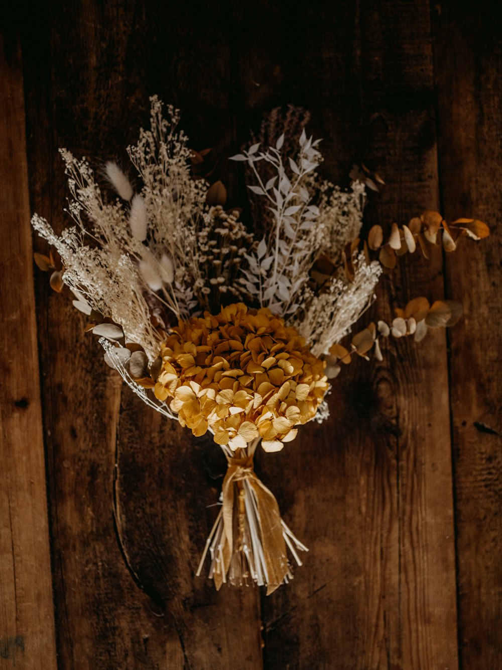 white flowers on brown wooden wall