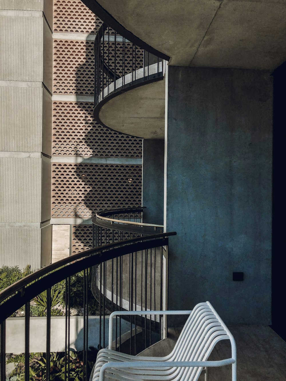 black metal spiral staircase near brown concrete building during daytime