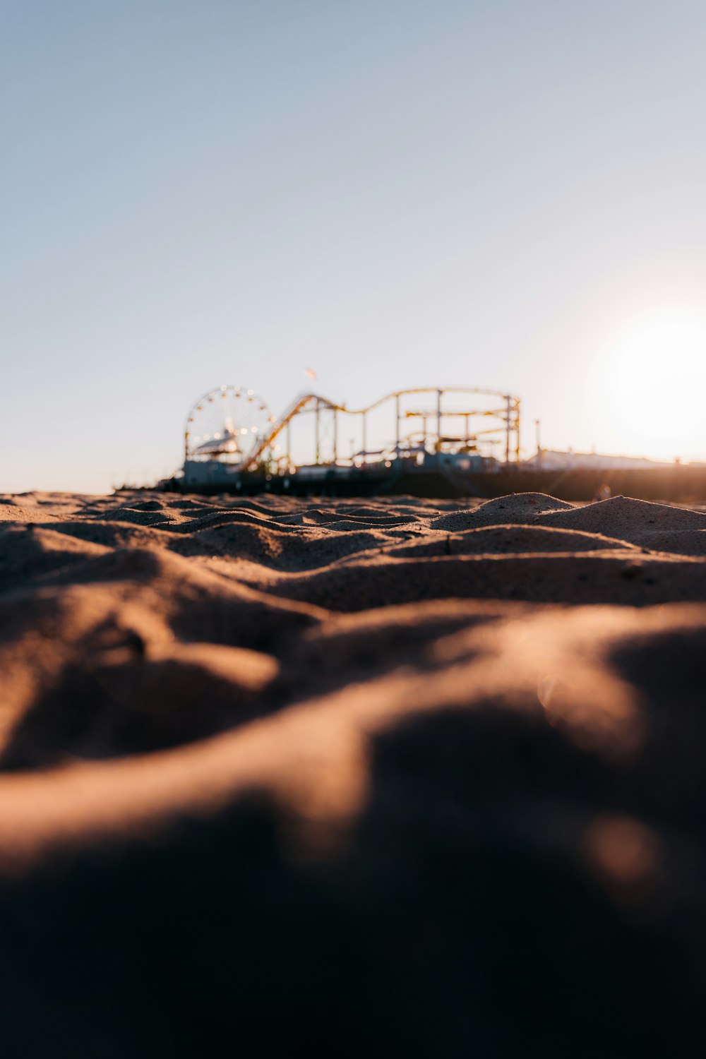 silhouette of roller coaster during sunset