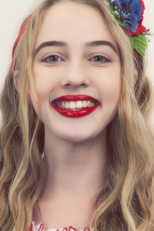 Smiling customer wearing LEGO hair pins and a matching necklace at a convention.