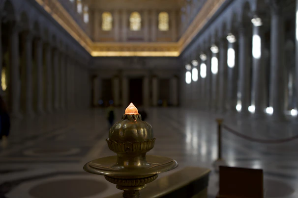 A faded archival photograph of a grand hall where ancient councils once convened, bathed in soft candlelight.
