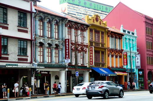 A vibrant street scene in Singapore bustling with tourists and colorful shops.