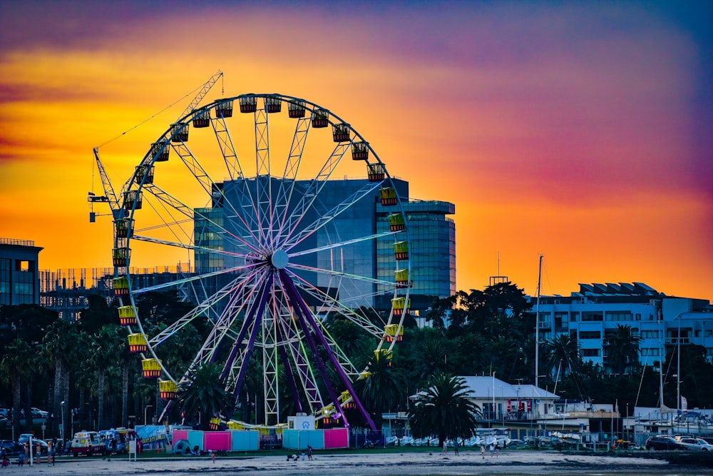 ferris wheel near city buildings during night time