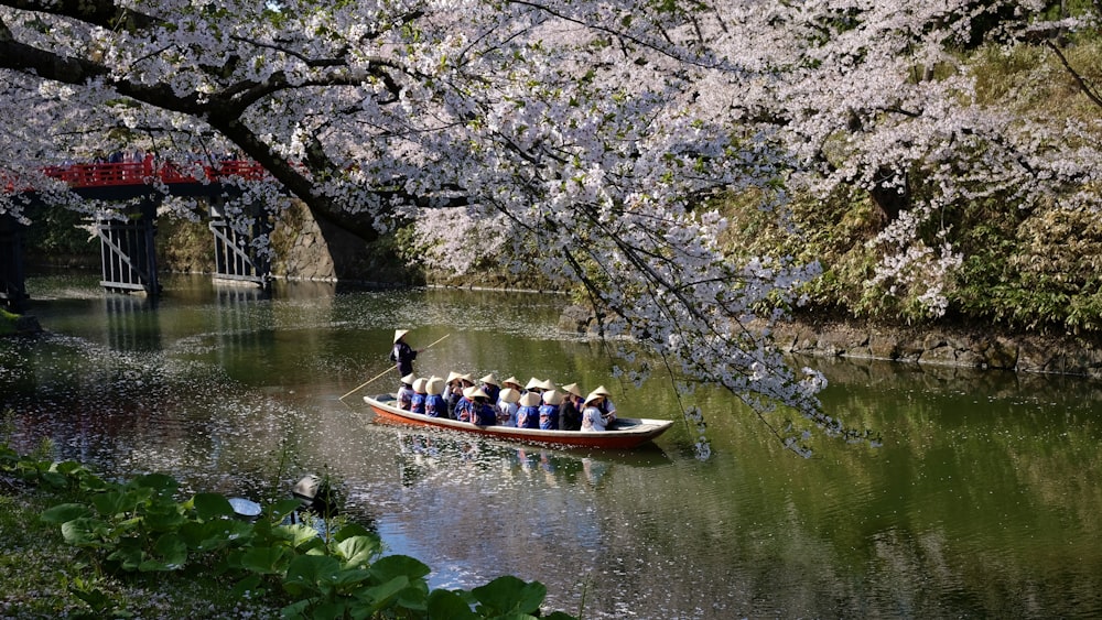 people riding on boat on river during daytime