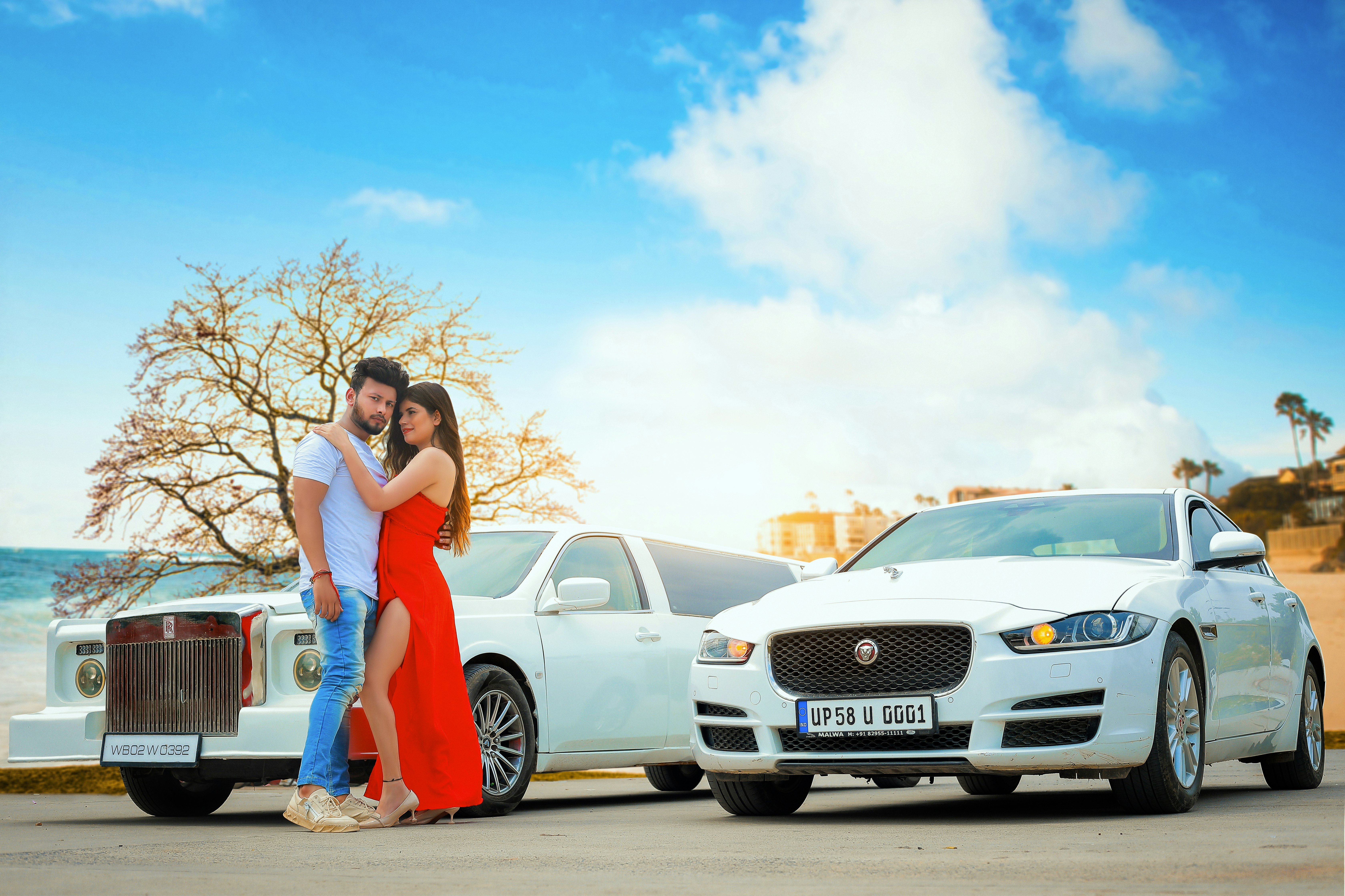 Couple reviewing paperwork while buying a used electric car at a dealership