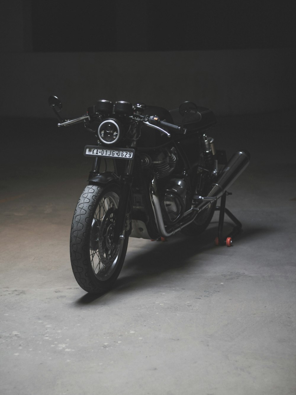 black motorcycle on gray pavement