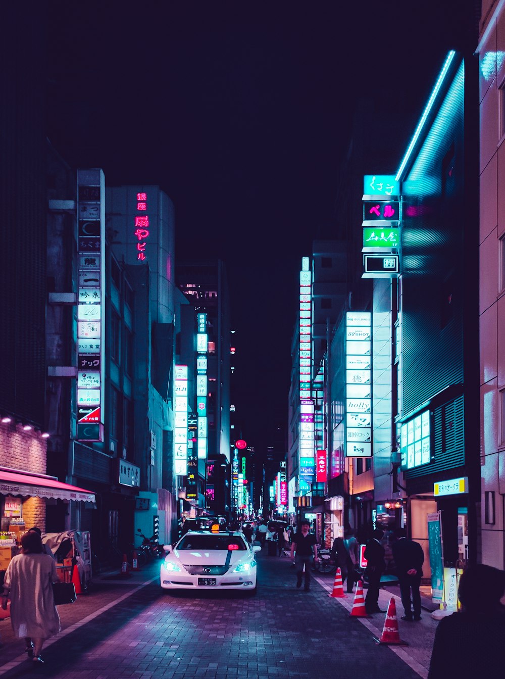 people walking on street during night time