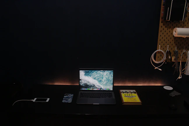 Calm workspace featuring navy and monochrome decor with modern tech gadgets.
