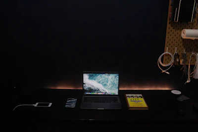 Minimalist workspace featuring laptop and travel gear in soft beige and ocean blue tones.