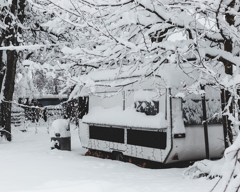 white and red bus on snow covered ground