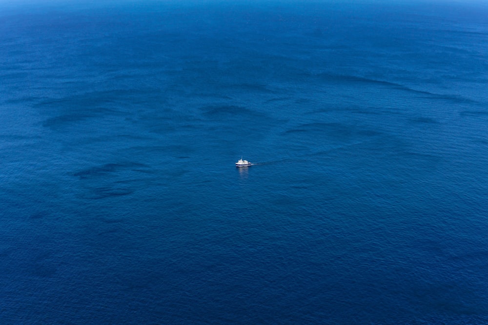 white boat on blue sea during daytime