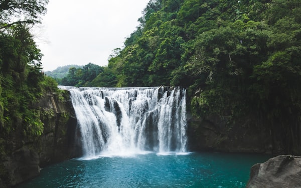 Waterfall with emerald pool in tropical jungle