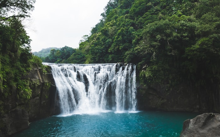 Waterfall with emerald pool in tropical jungle