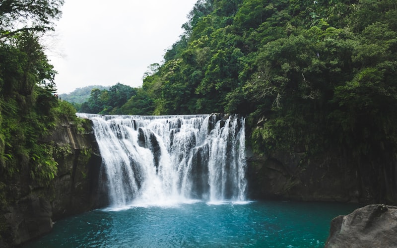 Waterfall with emerald pool in tropical jungle