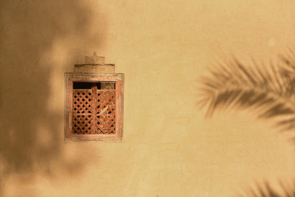 brown wooden frame on white wall