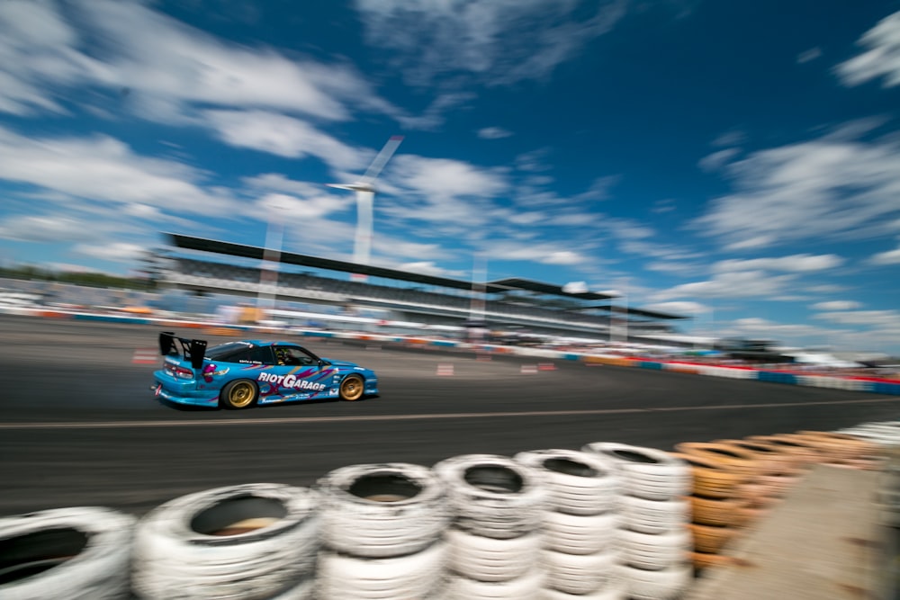 blue and white f 1 on race track during daytime