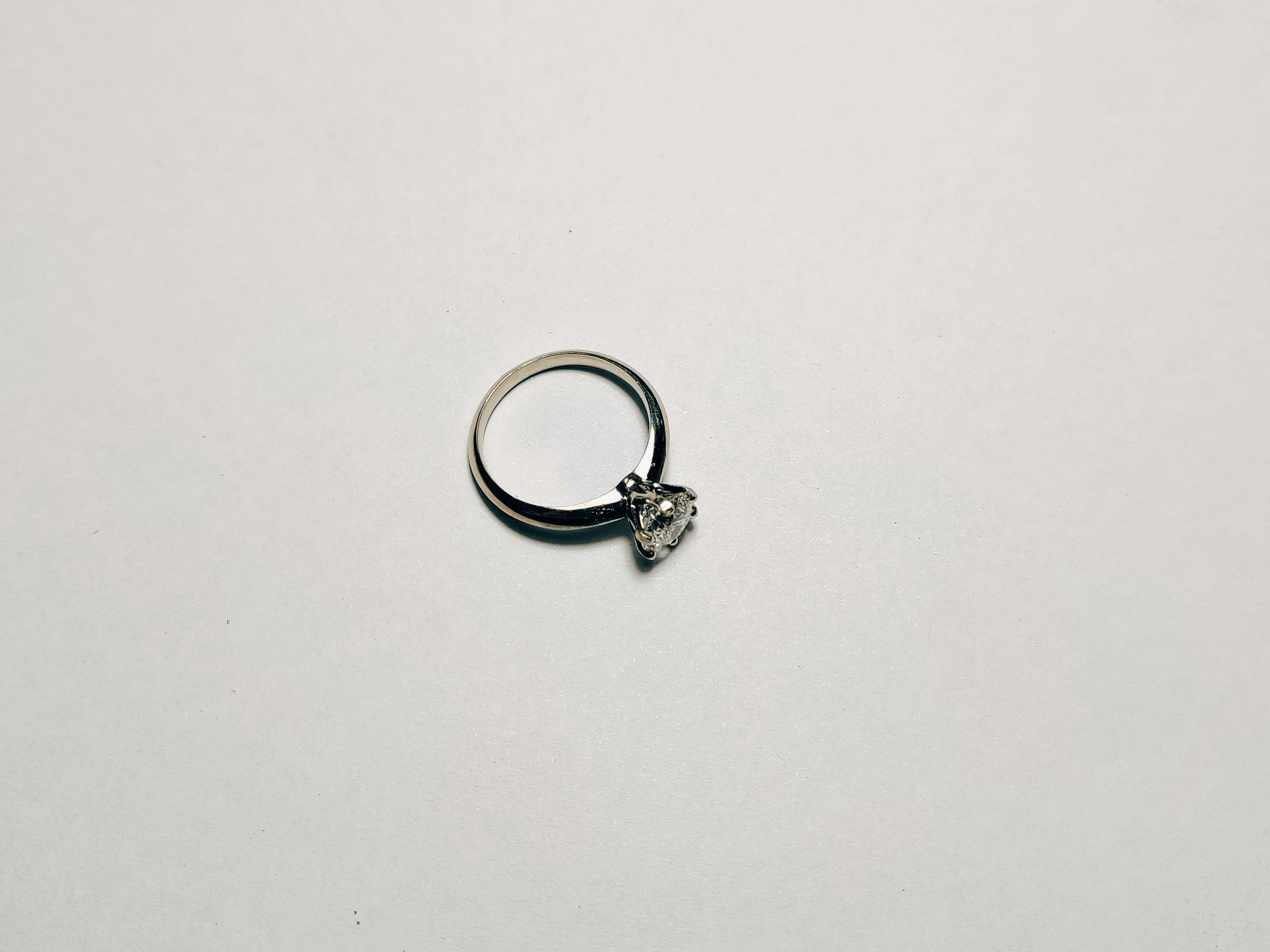 gold ring on white surface