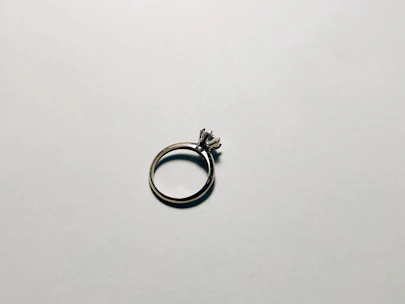 Close-up shot of a jeweler delicately polishing a silver ring under soft, natural light.