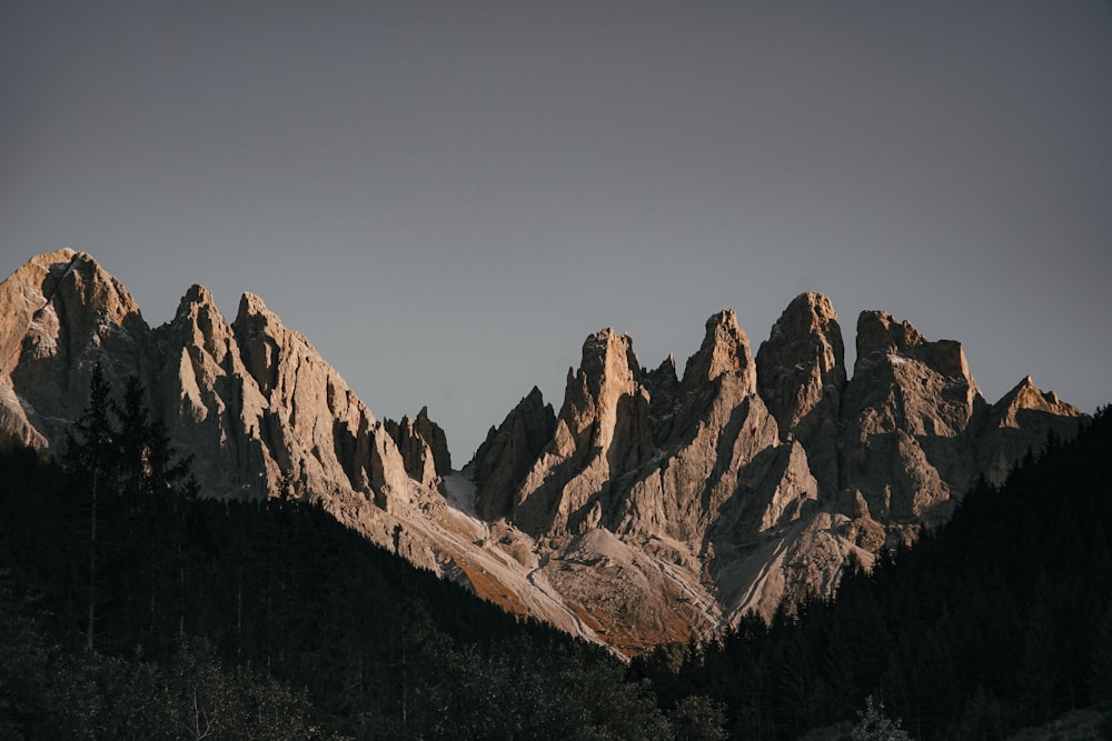 brown rocky mountain under gray sky