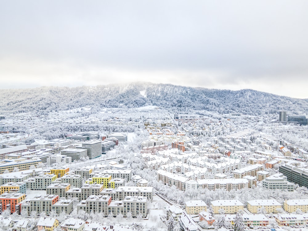 white and brown concrete buildings near mountain during daytime