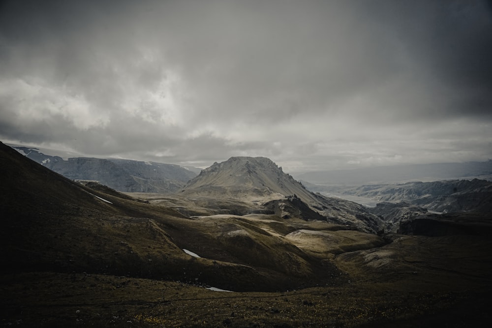 snow covered mountain under cloudy sky during daytime