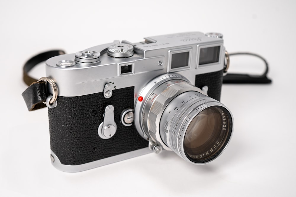 black and silver camera on white table