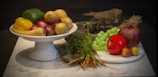 A still life arrangement of healthy fruits and vegetables.