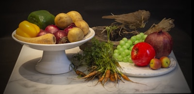 A still life arrangement of healthy fruits and vegetables.