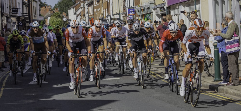 group of people riding bicycles on road during daytime