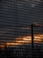 View of automated blinds closing at dusk, demonstrating modern home control.