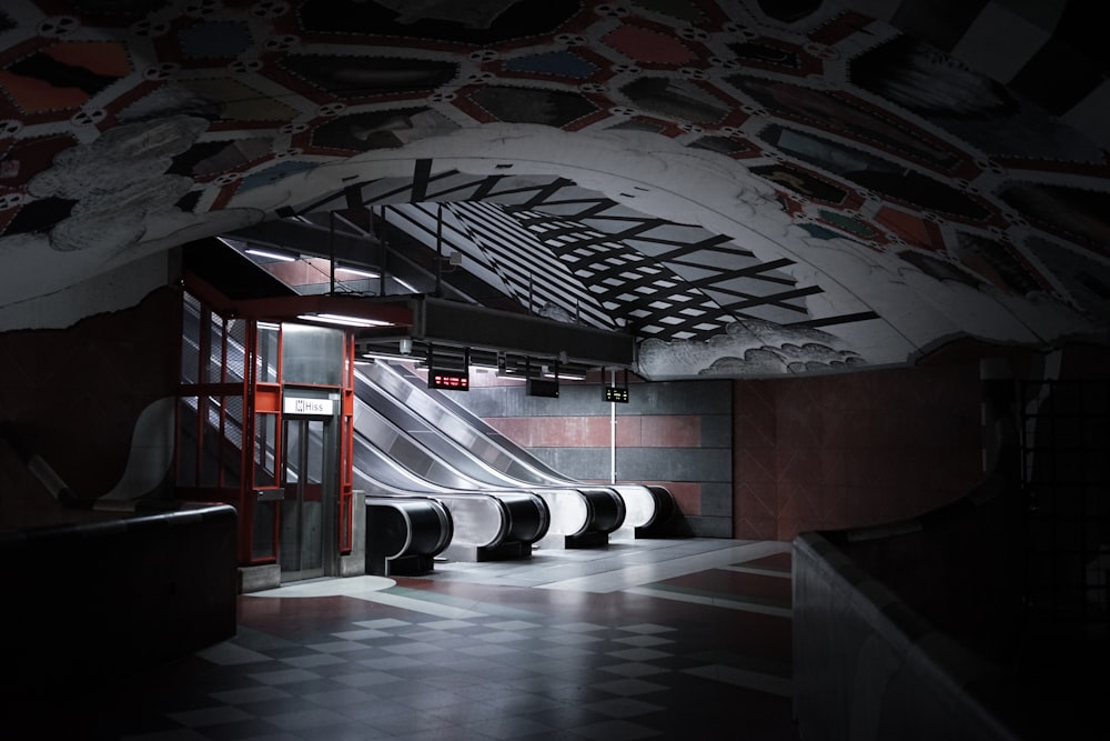 white and black escalator inside building