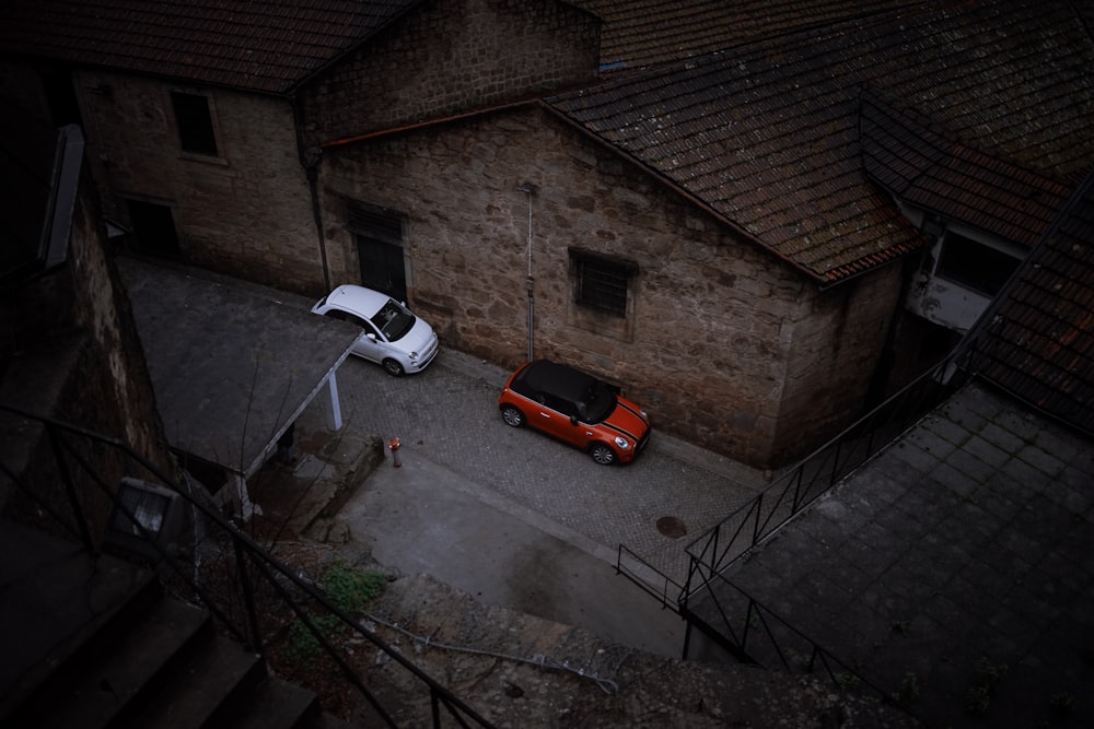 red car parked beside white car