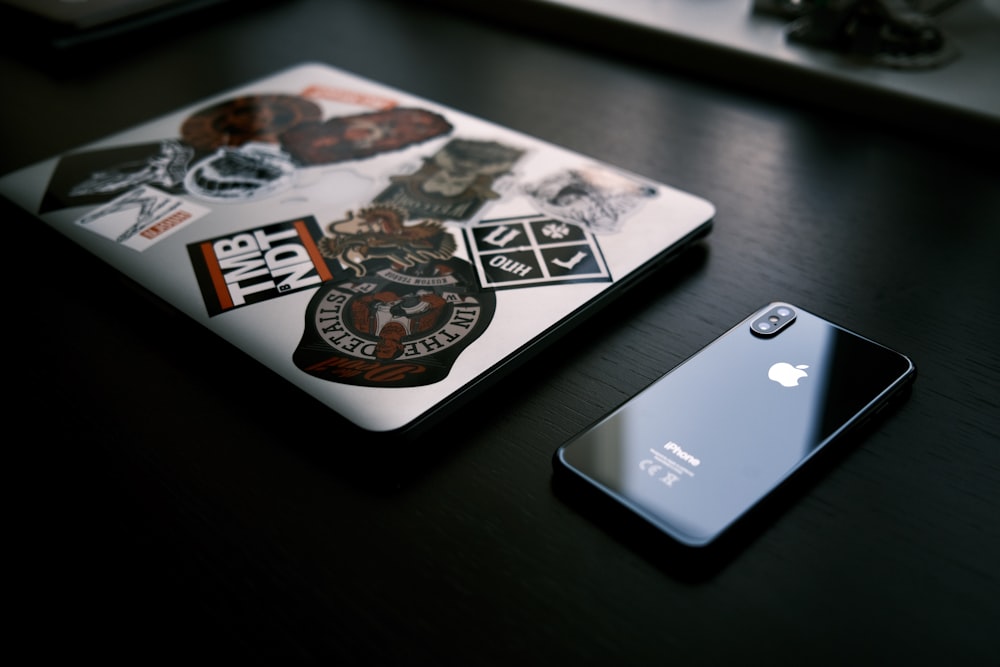 silver iphone 6 beside white and black ceramic plate