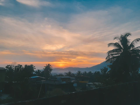Scenic sunset view over Kampial Hill villas with ocean backdrop.