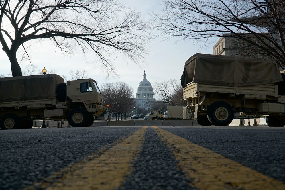 yellow truck parked near bare trees during daytime