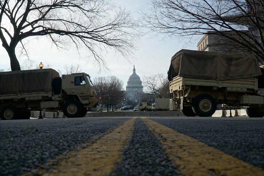 National Guard trucks parked on a street near the US Capitol this January (Ian Hutchinson via Unsplash)