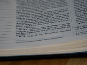 A close-up view of an open book showing printed text with some underlined words. The text appears to be a passage, possibly from a religious or spiritual book.